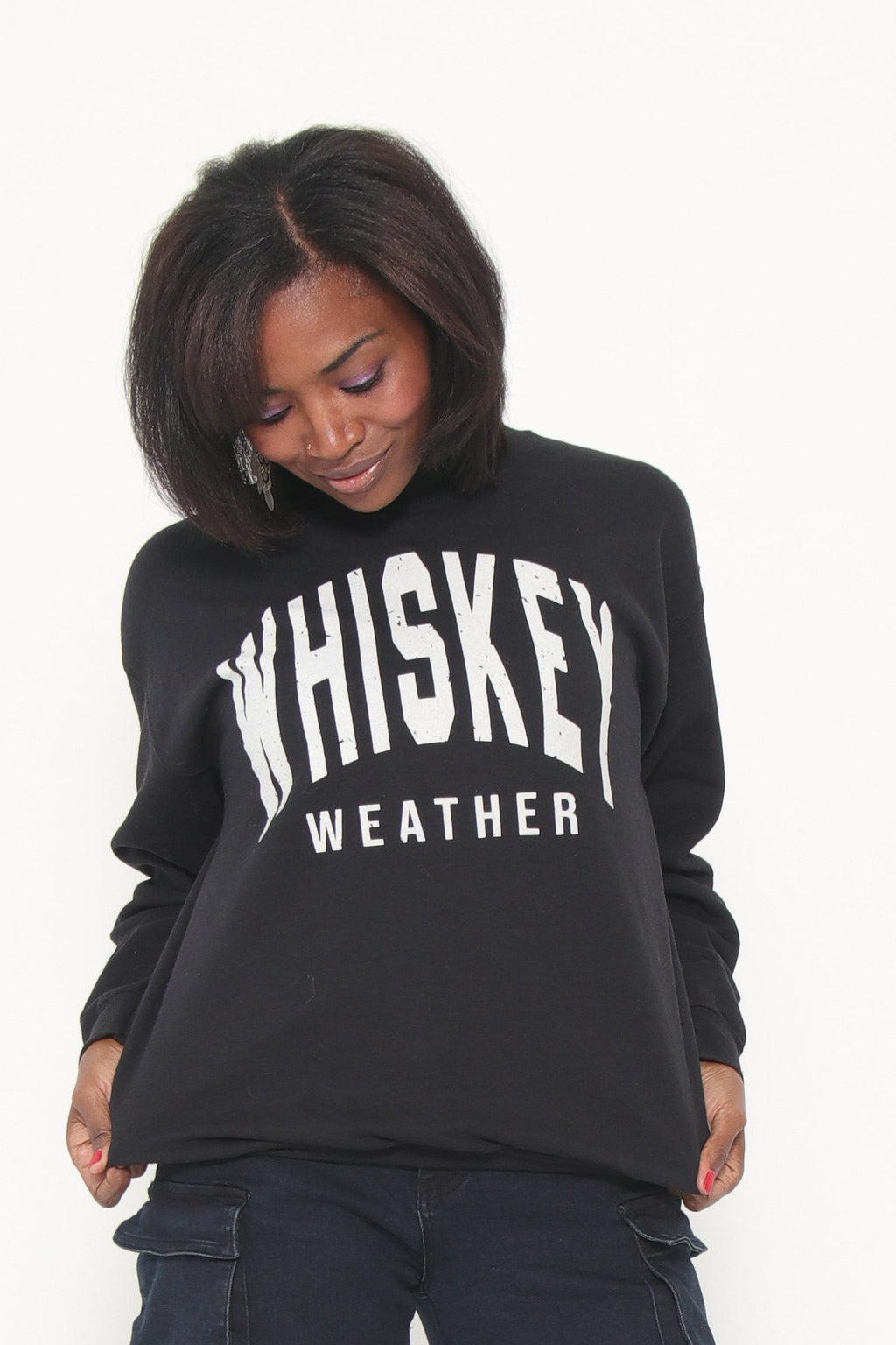 Person wearing a black hoodie with text on a white background