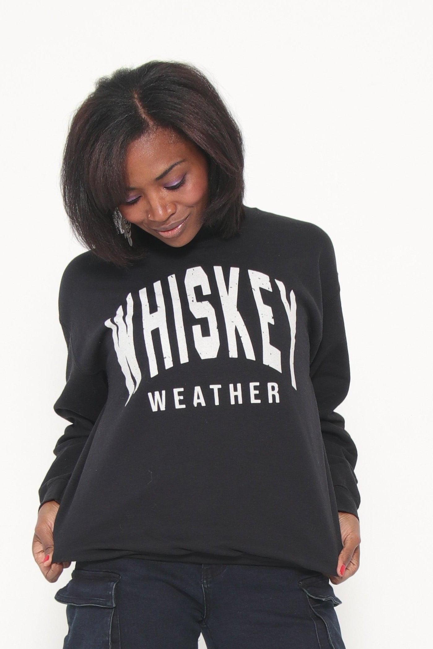 Person wearing a black hoodie with text on a white background