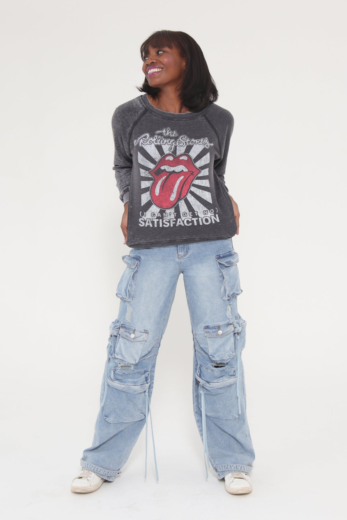 Person wearing a graphic hoodie and jeans on a white background