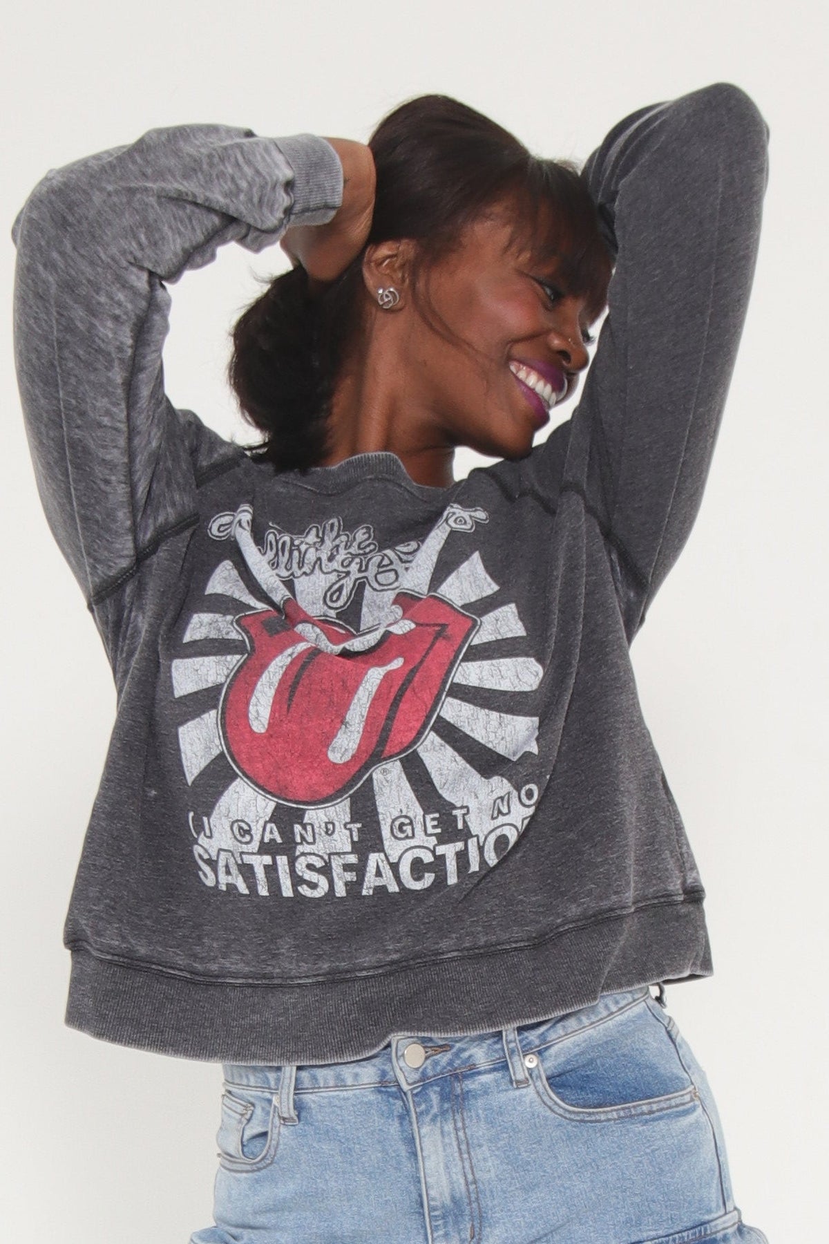 Person wearing a gray hoodie with Rolling Stones 'I Can't Get No Satisfaction' design on the back.
