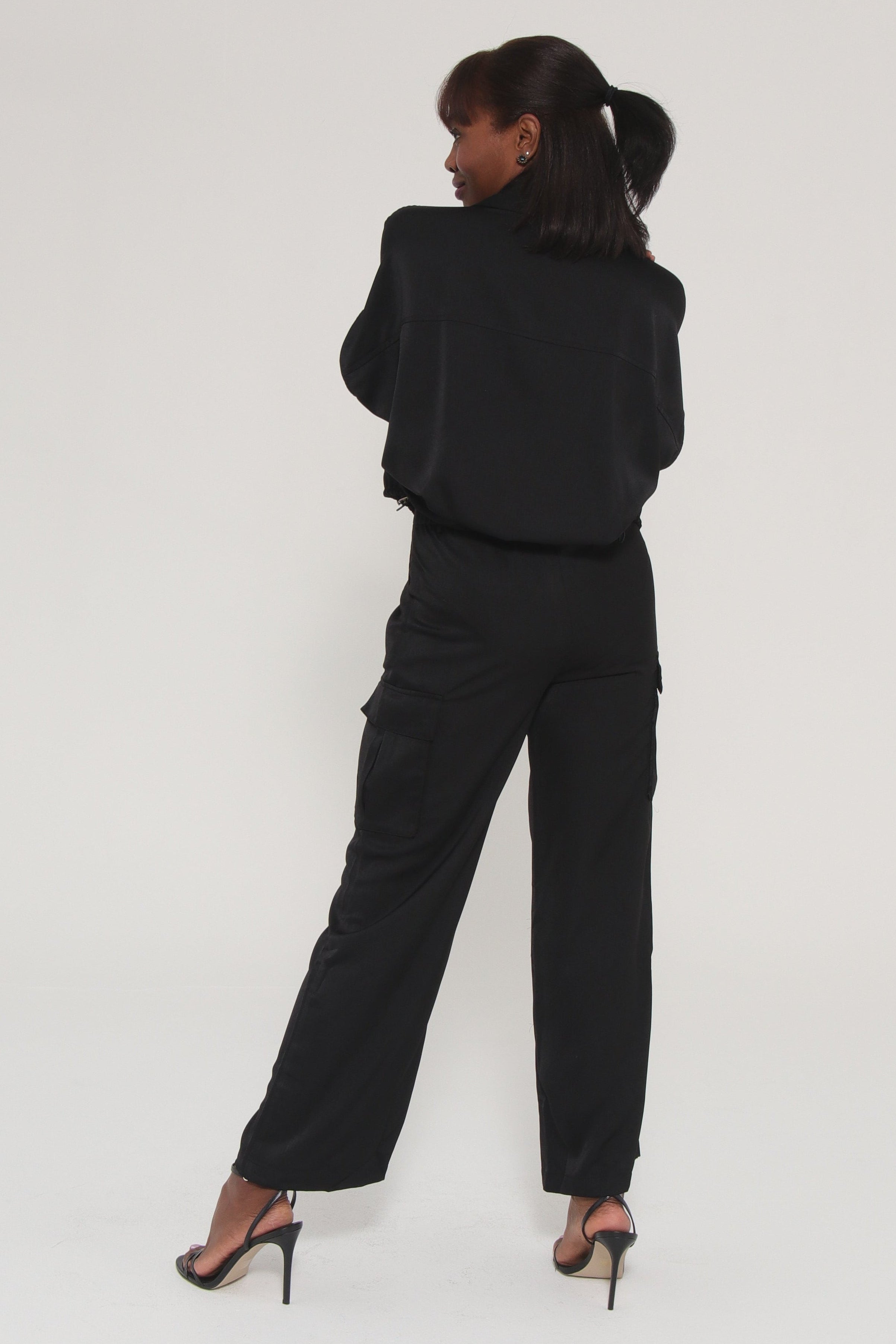 Person wearing a black outfit on a white background