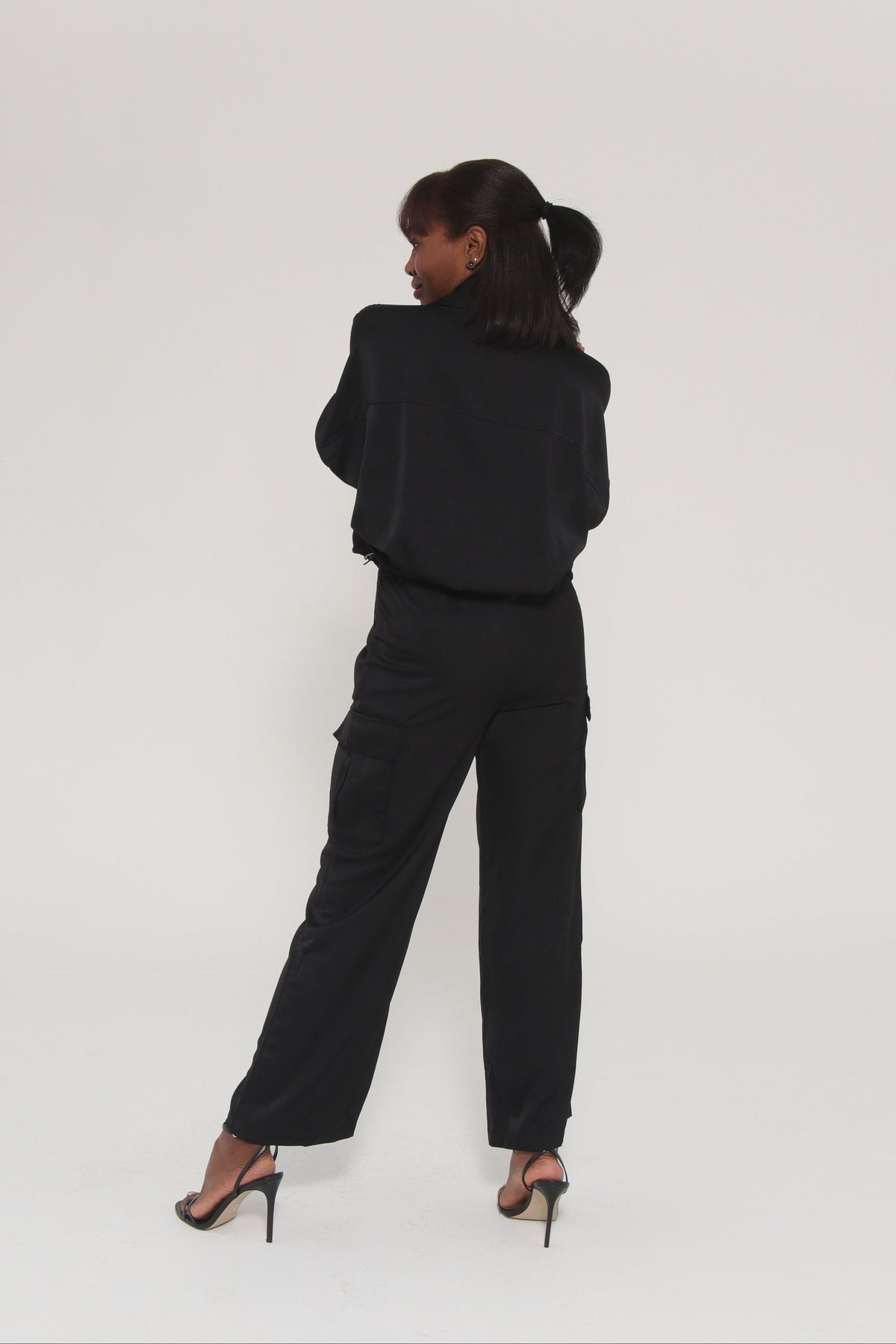Person wearing a black outfit on a white background
