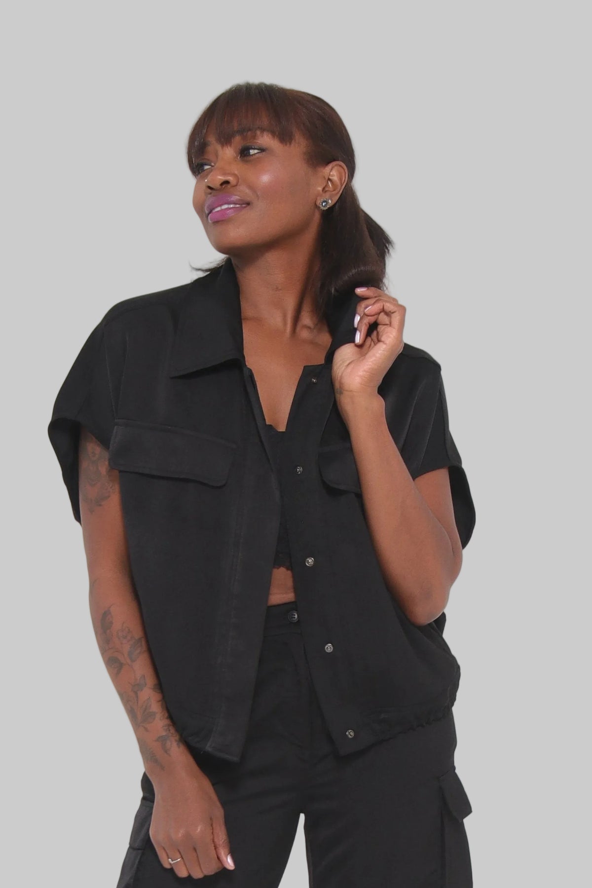 Person wearing a black outfit on a white background