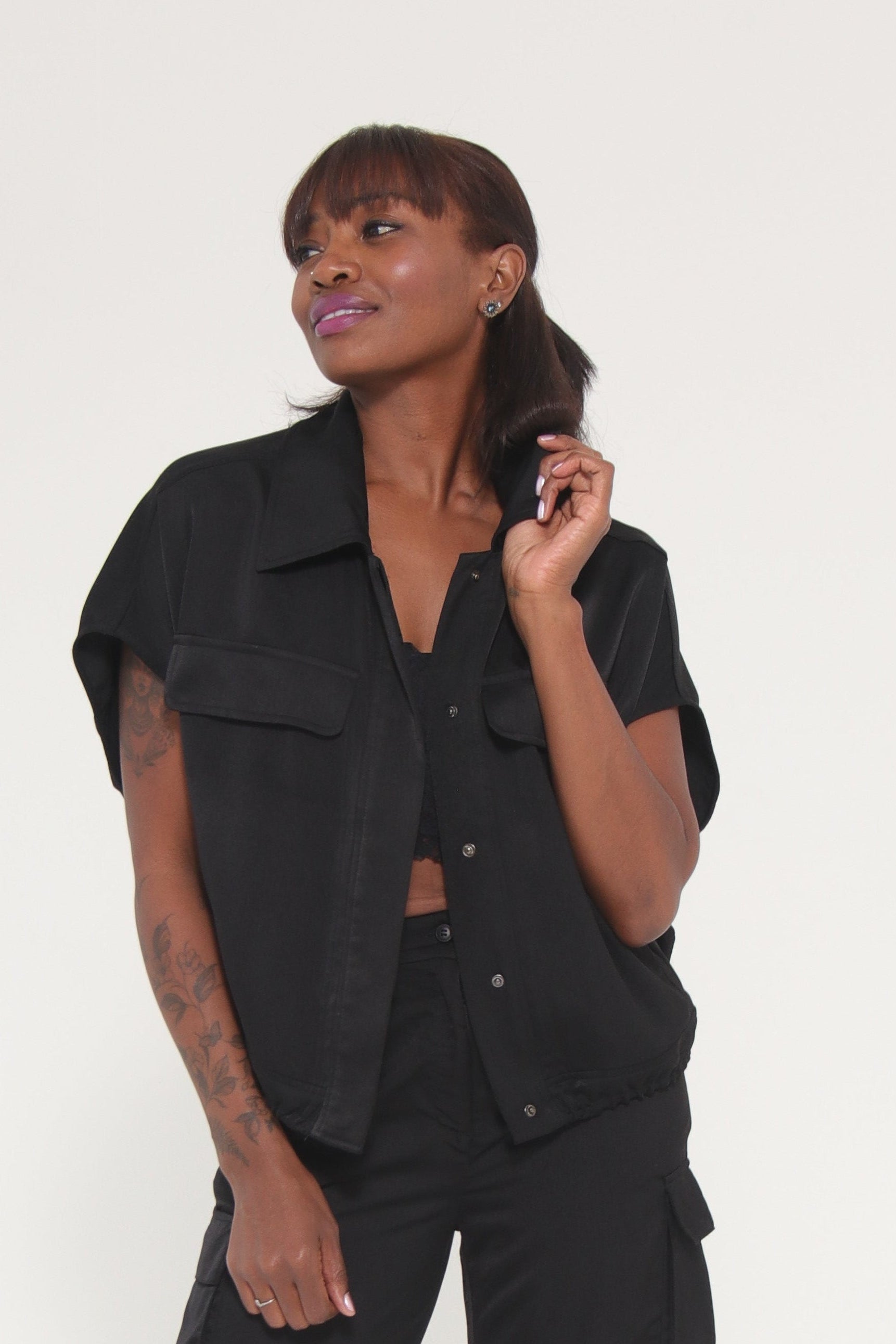 Person wearing a black outfit on a white background